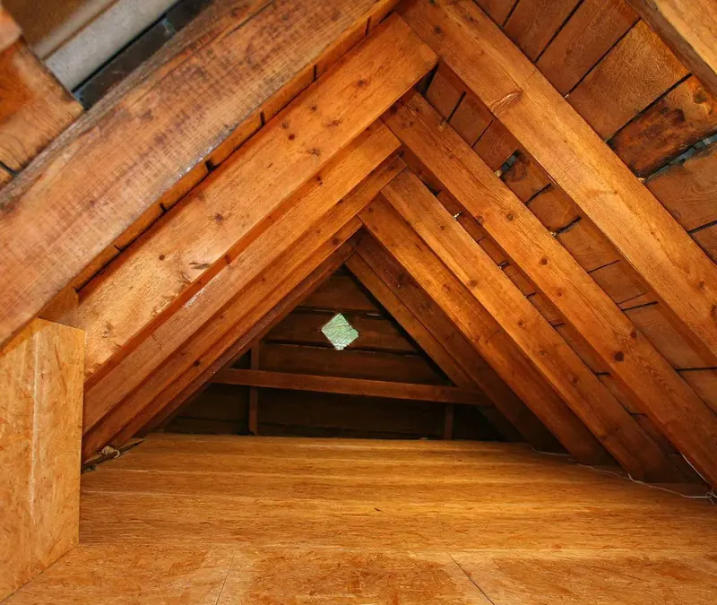 Clean, empty attic with exposed rafters