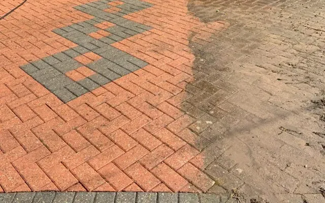 Paver driveway half cleaned, showing the difference