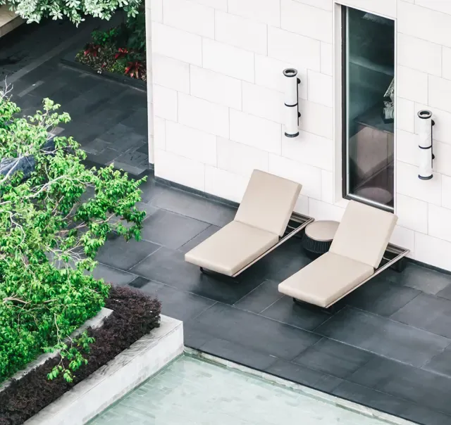Clean tiled patio with lounge chairs